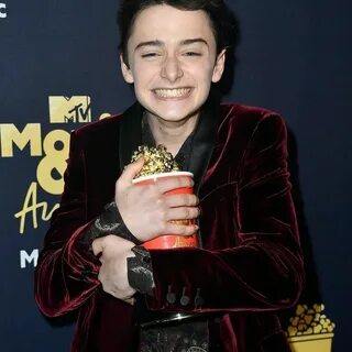 Noah Schnapp ( on the red carpet of with his prize in hand s