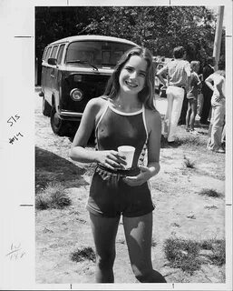 Actress Melissa Gilbert smiling and holding a cup of water a