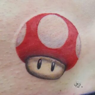 A cute tattoo of a recent design of the Mario magic mushroom