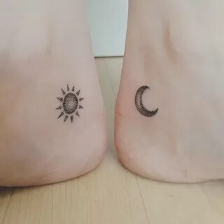 Matching hand poked sun and moon tattoos.