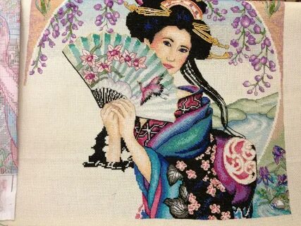 Vintage framed embroidery japanese woman near candle