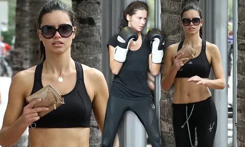 Adriana Lima shows off washboard stomach after a workout in 