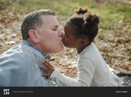 Close-up of daughter kissing father stock photo - OFFSET