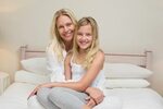 Happy mother and daughter lying on the floor - Stock Photo ©