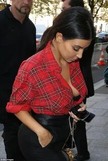 Kim Kardashian exposes cleavage in shirt on way to Givenchy 