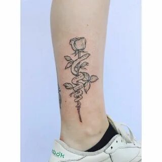 Ankle tattoo of a snake wrapped around a rose Rose tattoo on