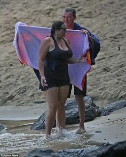 Shirtless Pierce Brosnan wraps towel around his wife Keely i