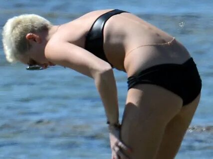 Miley Cyrus yoga in black bikini on beach in Hawaii 1/24/13 