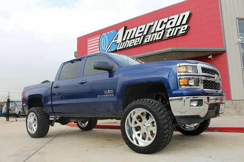 Lifted Chevy Silverado 1500 rolling on 35" tires wrapped aro