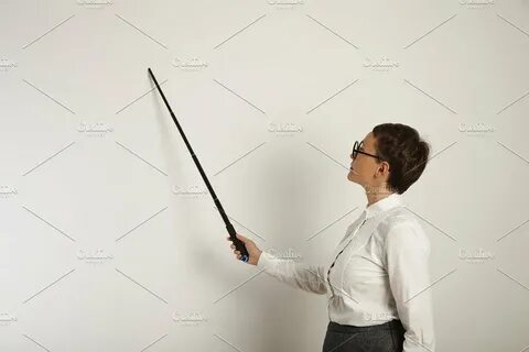 Female teacher with a pointer at white board containing teac