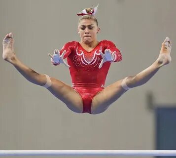 Ashton Locklear of the United States performs on the uneven 