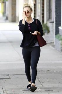 kaley cuoco flashes the peach sign with a smile as she run e