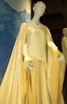Eowyn's boat-necked, butter-gold gown for Aragorn's coronati