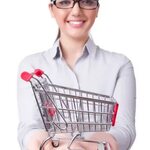 Young woman with shopping cart on white - License, download 