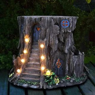 The Tree Stump Fairy House has solar powered lighting to lea