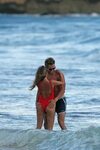 kaitlyn bristowe wears a red swimsuit while she enjoys a str