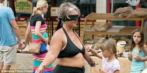 Amy Pence-Brown strips down to a bikini in a market to promo