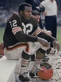 Browns RB Jim Brown rests on the sidelines during a 1963 gam