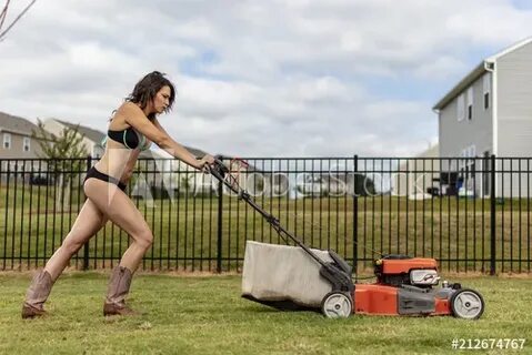 A Gorgeous Bikini Clad Model Mowing The Lawn фотография Stoc
