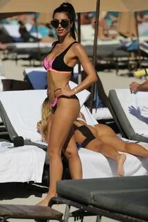 metisha schaefer puts on a pink and black bikini while enjoy