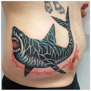 Illustrative shark tattoo on the right side hip. 
