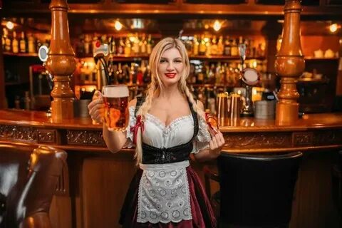 Premium Photo Sexy waitress holds two mugs of fresh beer at 