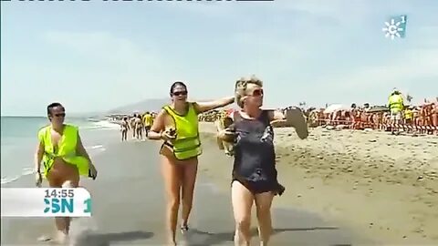 Mature Spanish nudists walk around the beach completely nake