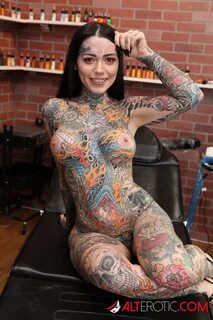 Heavily tattooed girl Tiger Lilly gets a new tattoo while co