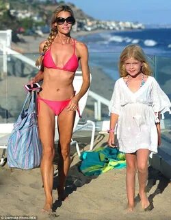 Denise Richards shows off bikini body whilst hitting beach w