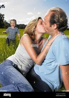 Mother and father kissing Stock Photo - Alamy