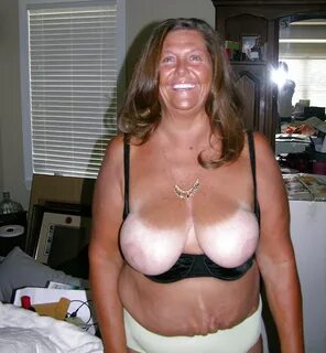 Overly tanned old woman big boobs