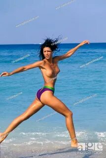 Woman running on the beach in topless, Stock Photo, Picture 