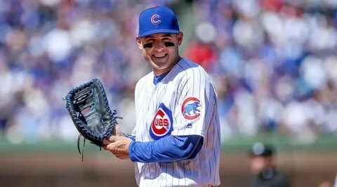 Anthony Rizzo stands on top of wall, reaches into stands for