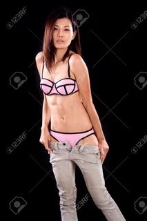 Chinese Woman In Underwear Pulling Down Jeans Фотография, ка