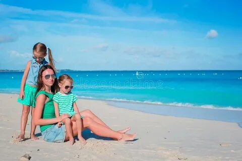 Mother and Daughters Enjoying Time at Tropical Beach Stock P