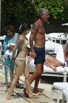 Asia Argento In bikini by the pool with Anthony Bourdain - R