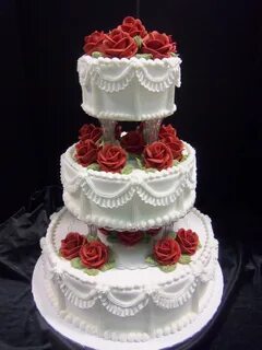Traditional butter cream iced cake with columns, scalloped r