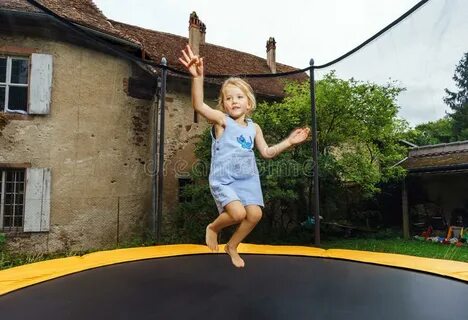 Cute Preschooler Girl Jumping on Trampoline Stock Image - Im