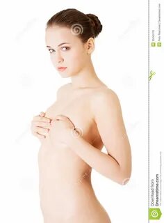 Attractive young naked woman holding her breasts. 