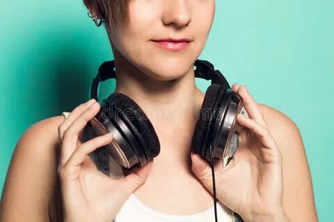 Music Headphones on a Girl`s Neck.Woman with Music Helmets S