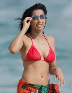 Indian actress Padma Lakshmi in red bikini on a beach