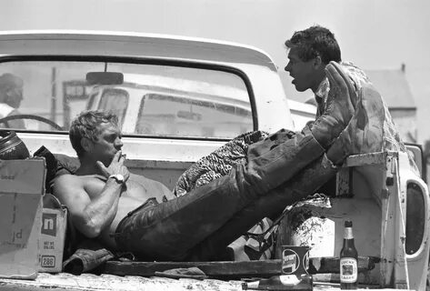 Steve McQueen takes a lunch break during a motorcycle race w