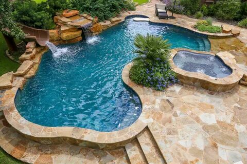 Beach entry swimming pool with a slide and waterfall Luxury 