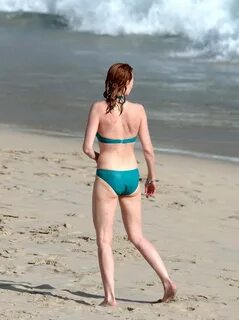 Marg Helgenberger wearing a turquoise bikini on a beach in S