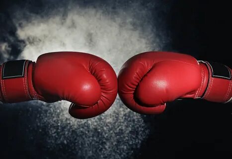 Men in boxing gloves on black background.