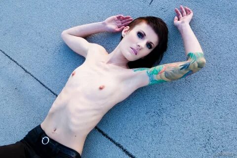 Skinny alt babe with tattooed body exposing tiny tits outdoo