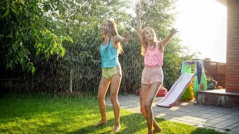 Image of Two Happy Laughing Teenage Girls Jumping and Dancin
