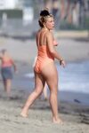 florence pugh seen wearing an orange swimsuit while enjoying