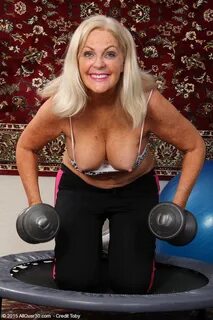 Mature mom Judy Mayflower lifts weights topless & spreads tw
