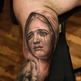 Virgin mary crying tattoo meaning